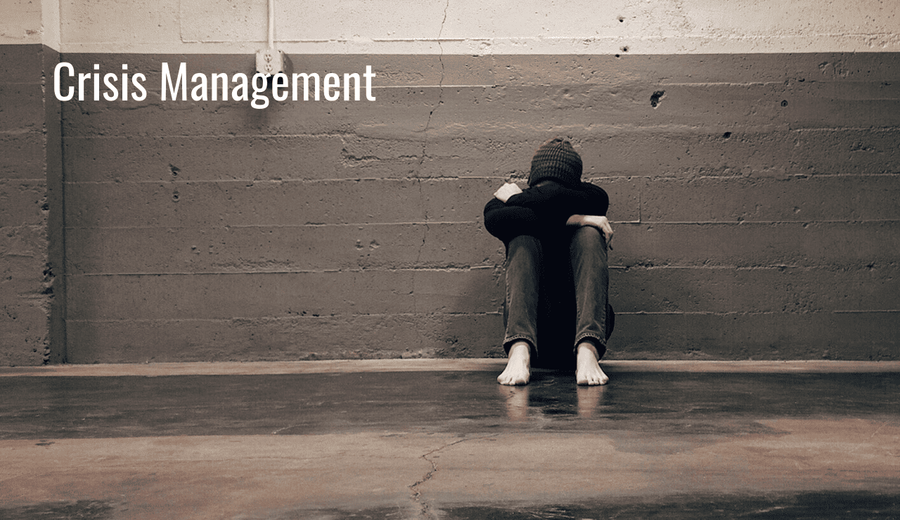 Crisis managemnt A boy sits with his head down because he is in a crisis due to his SUD