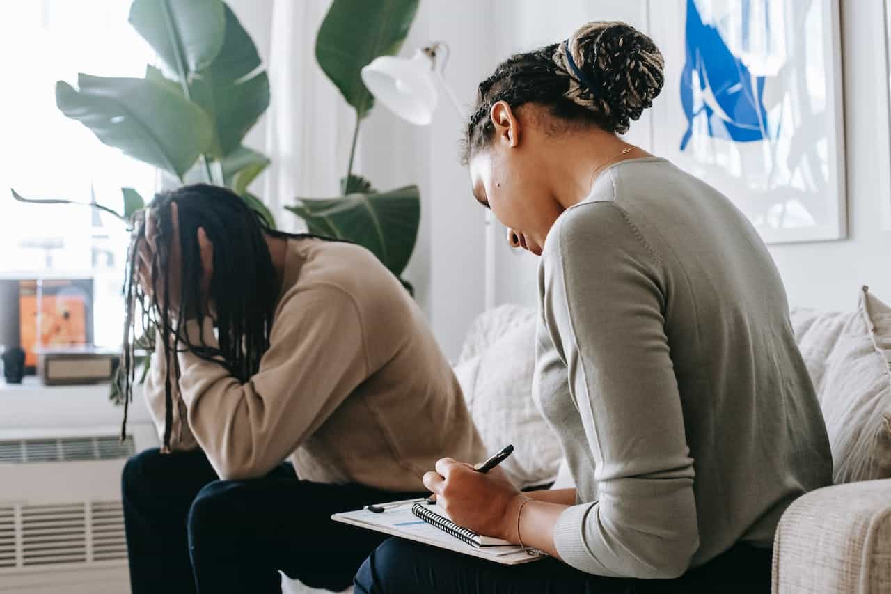 A man is coming to terms with his PTSD during a  drug counseling seeking safety  therapy session.