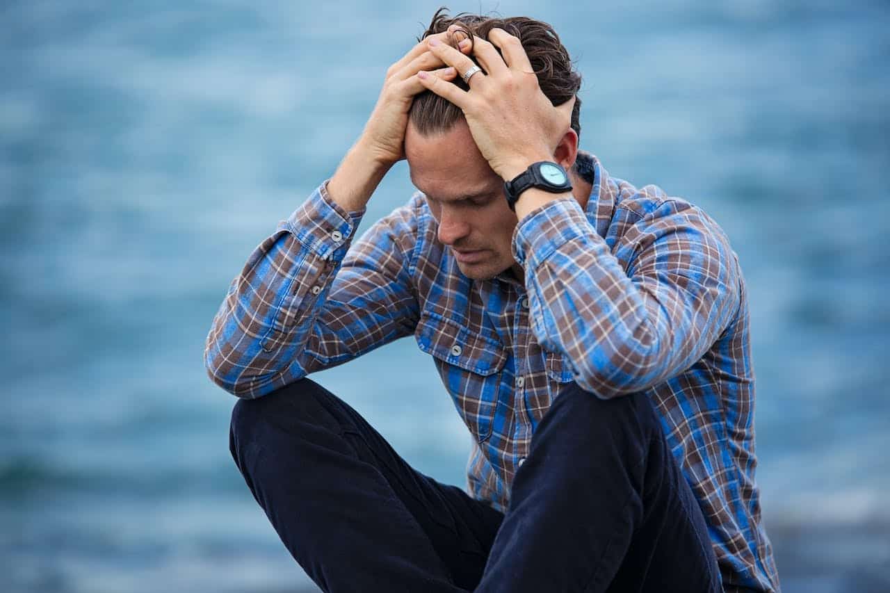 A man is coming to terms with his PTSD during a  drug counseling seeking safety  therapy session.