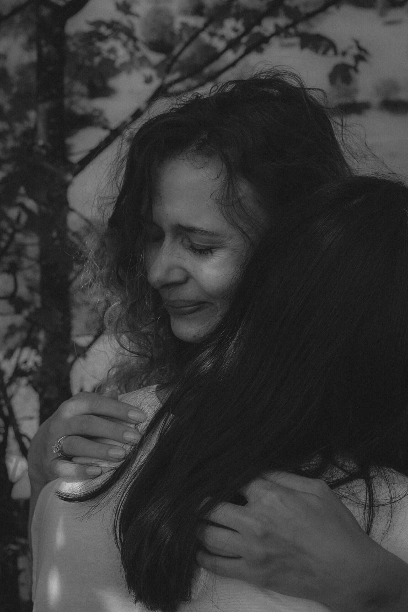 Two women embrace, having found the courage to seek treatment and face their fears by implementing the principles of trauma-informed care. Their decision marks a significant step towards healing and recovery, showcasing the power of compassionate and supportive care.