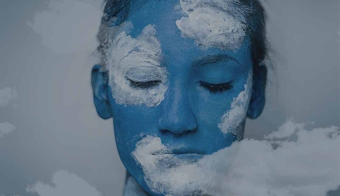 Educational Enhancements online CASAC Training for addiction counselor course shows a non-binary person with a painted face to look like clouds.