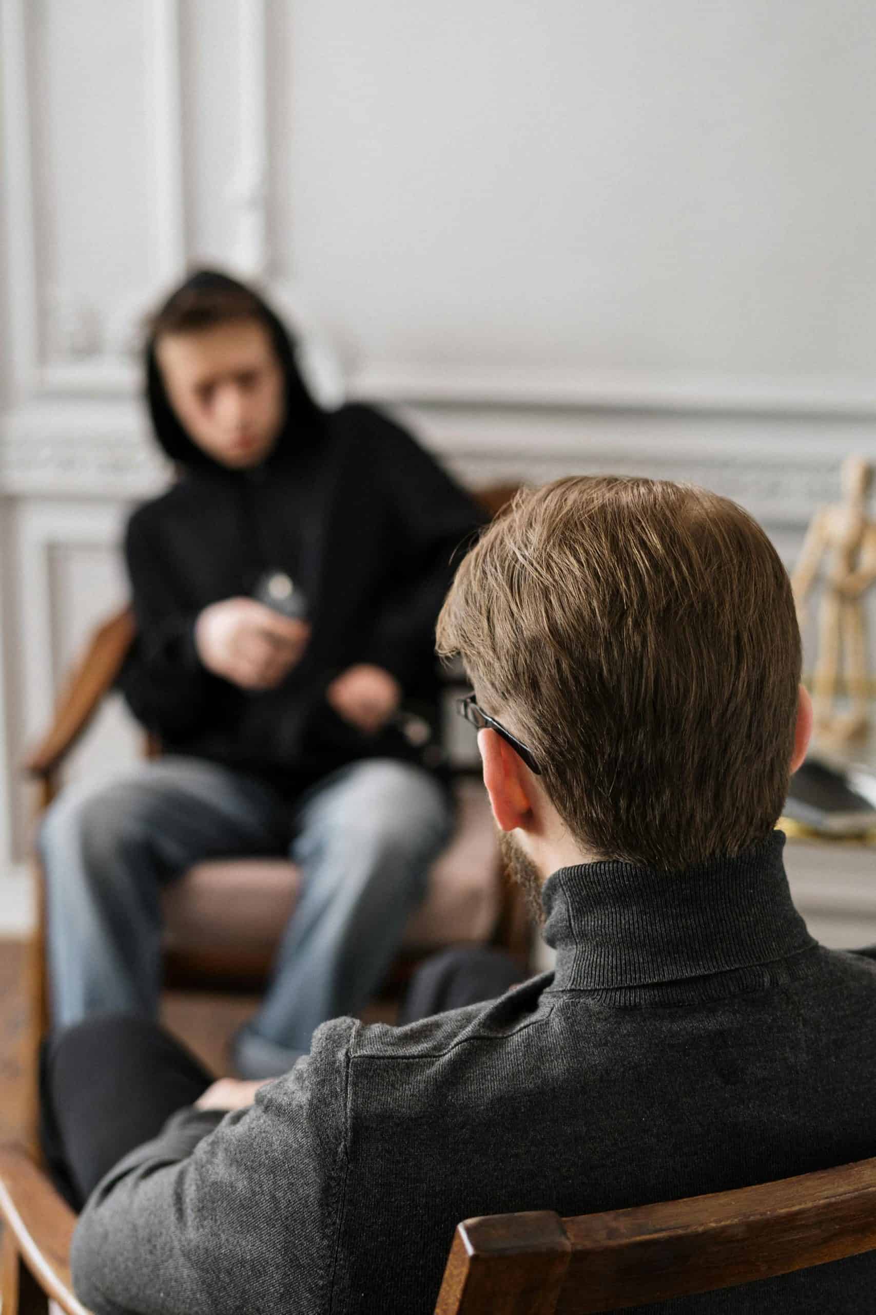 Addiction counselor speaking with a young client during a one-on-one counseling session as part of CASAC 350 training....