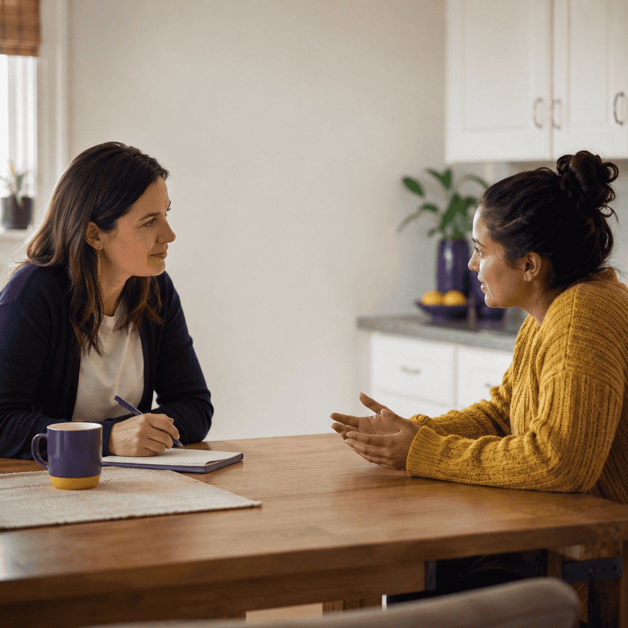 Two counselors sit discussing a client in a case conference which enhances the foundations of counseling